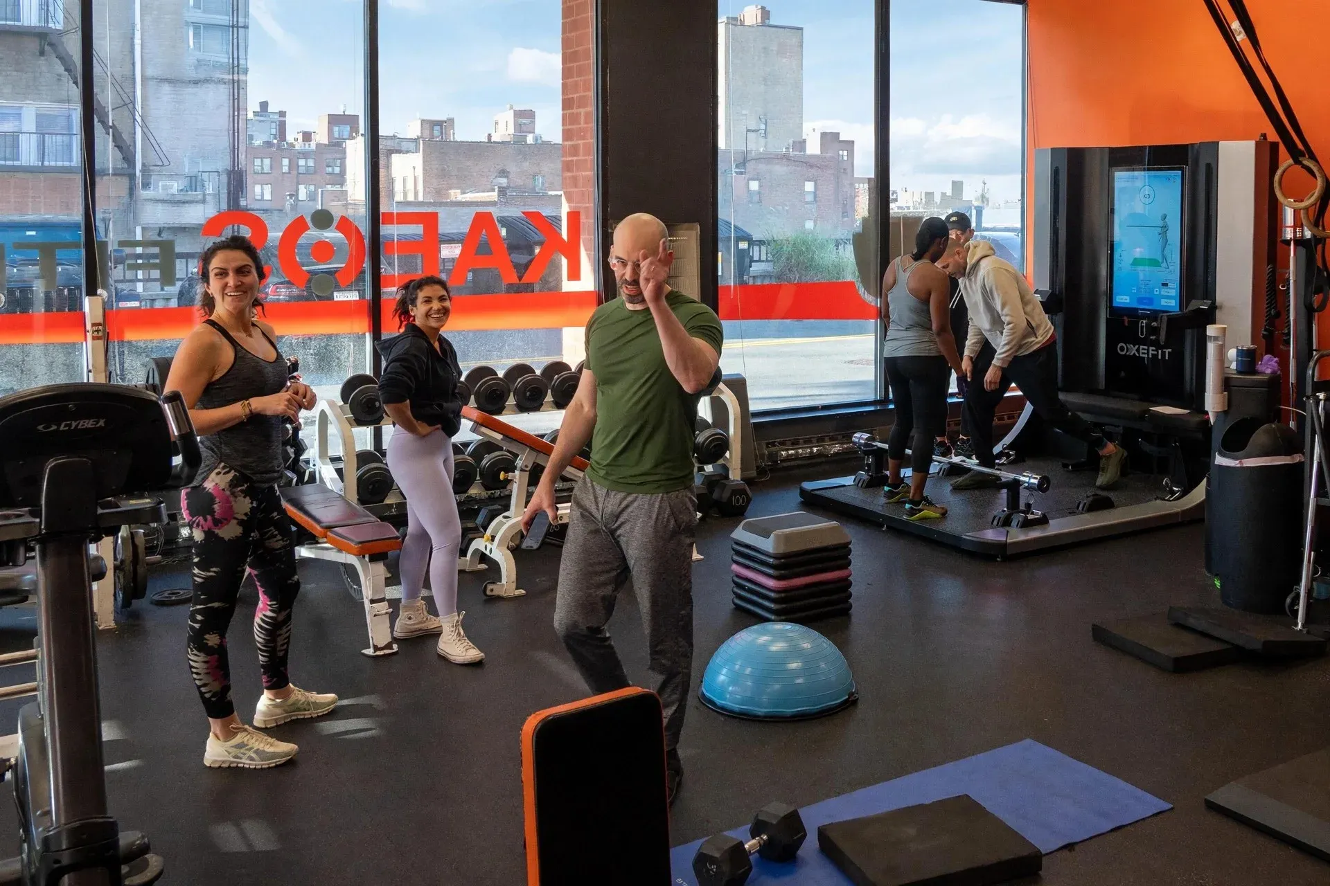 Coaches working with clients on the Kaeos Fitness training floor