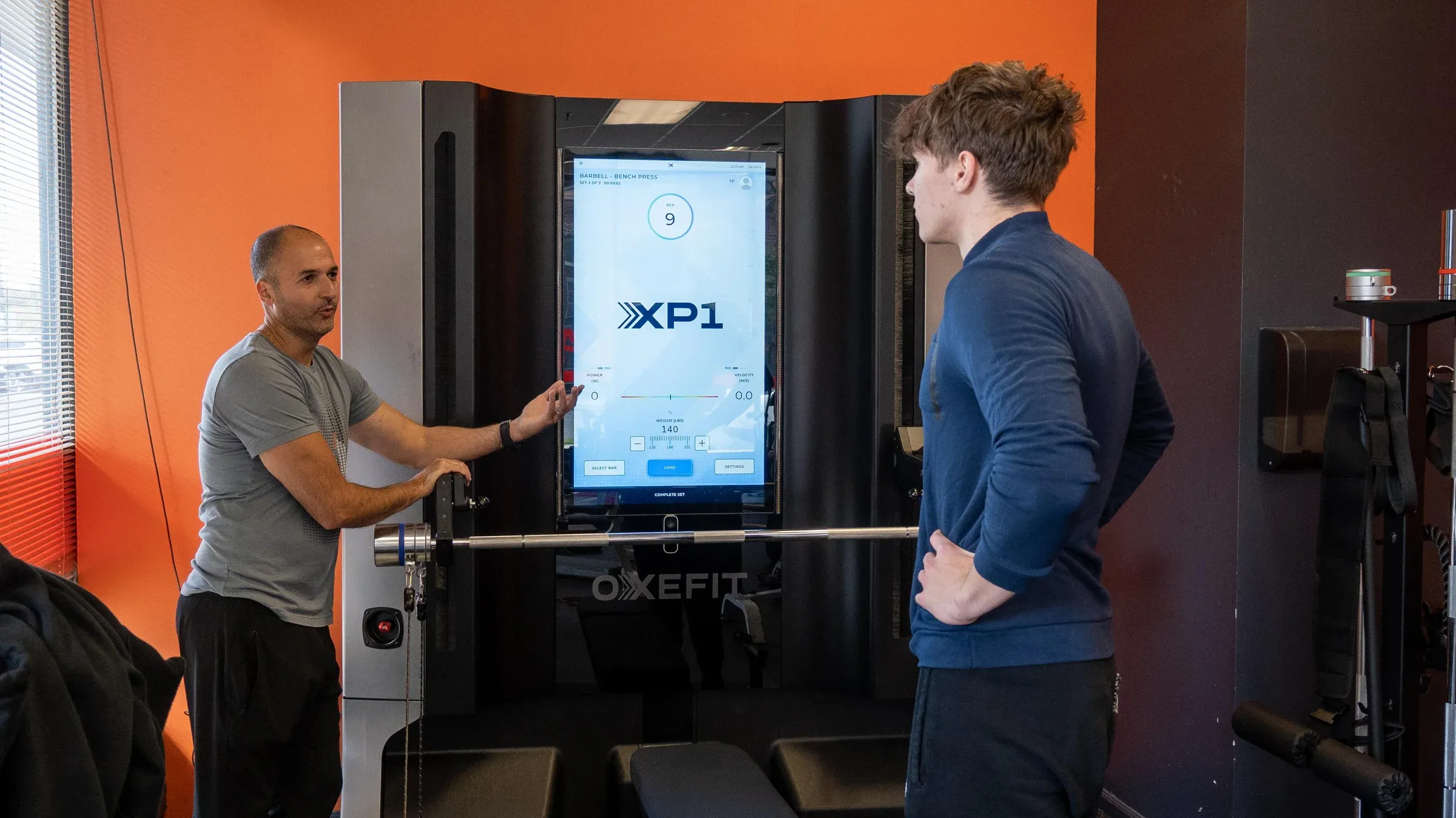 Client and coach at the OxeFit XP1 digital resistance trainer